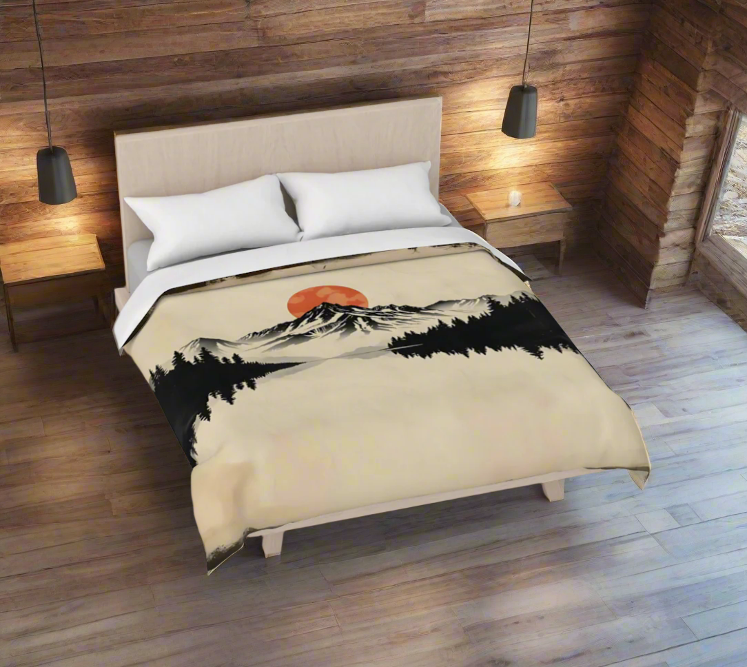 Bed with a duvet featuring a mountain and sunset design on a plain background