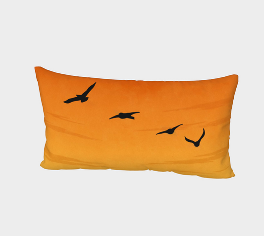 Orange pillow with black bird illustrations on a light gray background