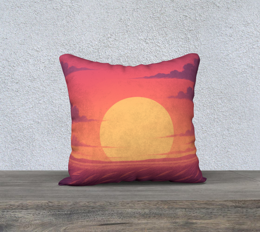 Decorative pillow with a sunset design on a wooden surface and light gray background