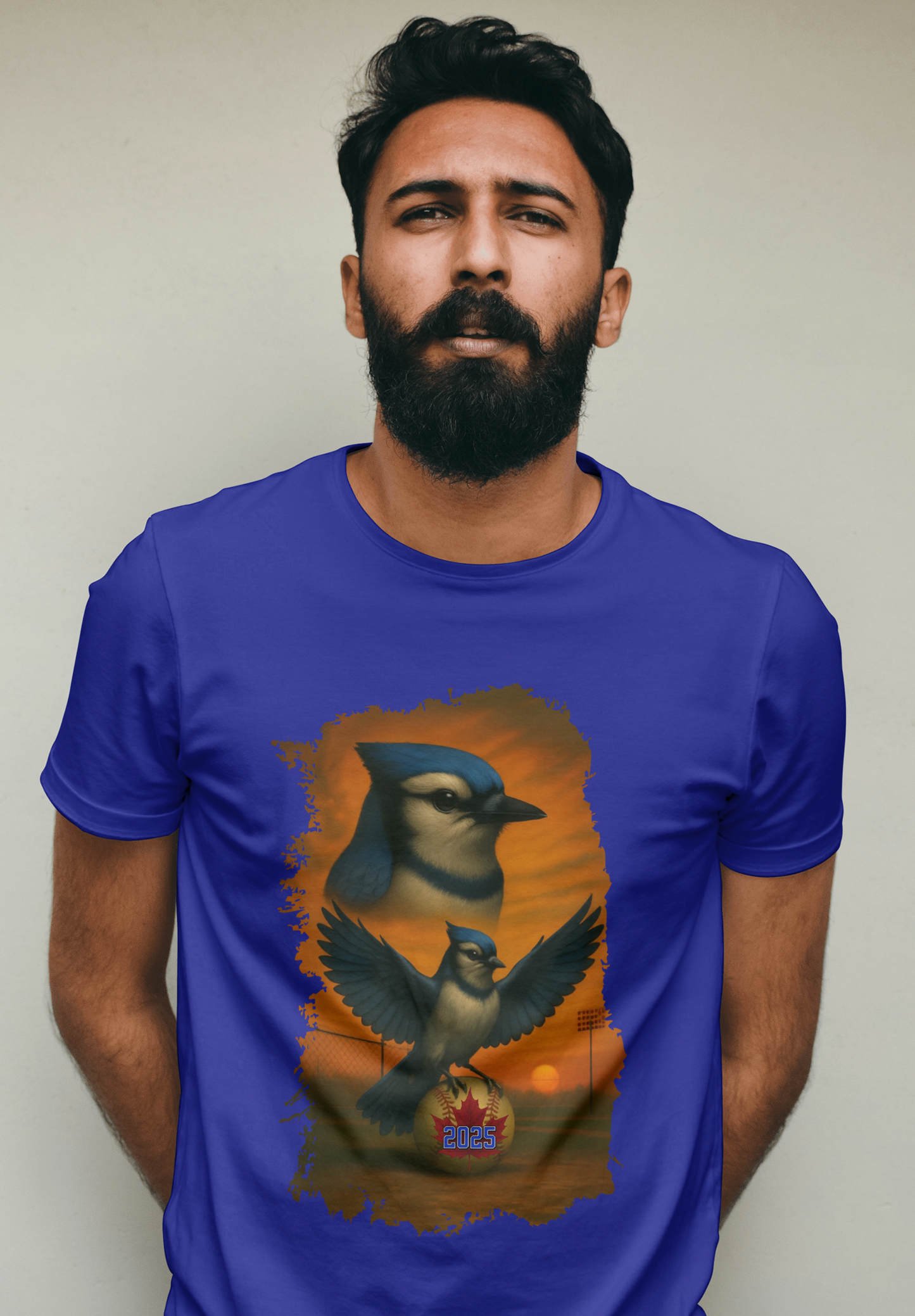 Man wearing a blue t-shirt with a bird graphic against a plain background